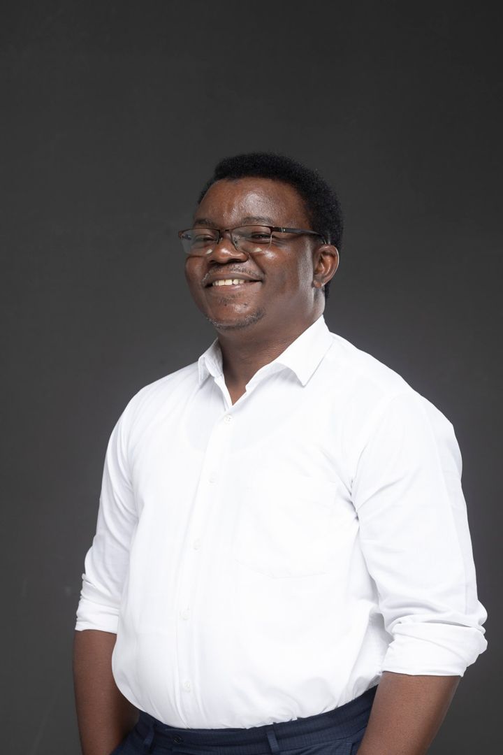 Chitambala Bruce in a white shirt with sleeves rolled up